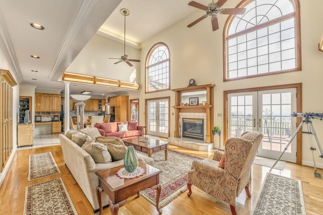 815 Battlefield Park Dr, Dalton, GA 30720 - living room with light hardwood / wood-style flooring, ceiling fan, a fireplace, ornamental molding, and french doors