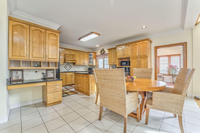 815 Battlefield Park Dr, Dalton, GA 30720 - kitchen featuring light tile patterned flooring, crown molding, built in desk, black microwave, and backsplash