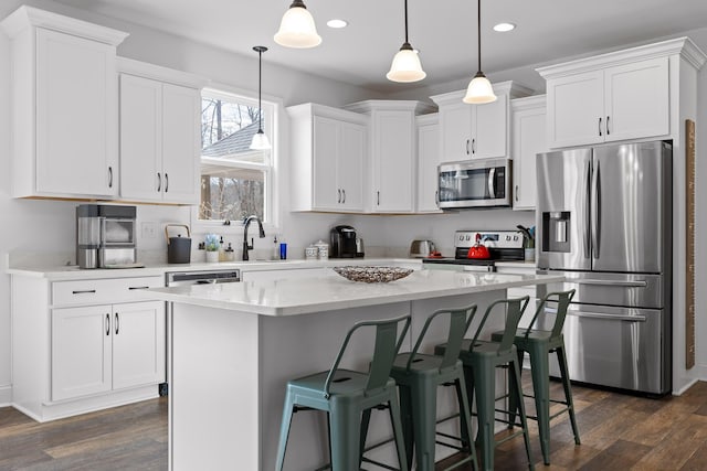 4700 Creek Point Ln, Signal Mountain, TN 37377 - kitchen with appliances with stainless steel finishes, white cabinets, dark wood-style flooring, a center island, and recessed lighting