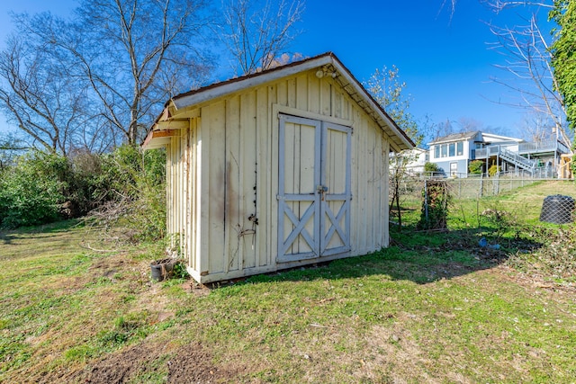 view of shed featuring fence