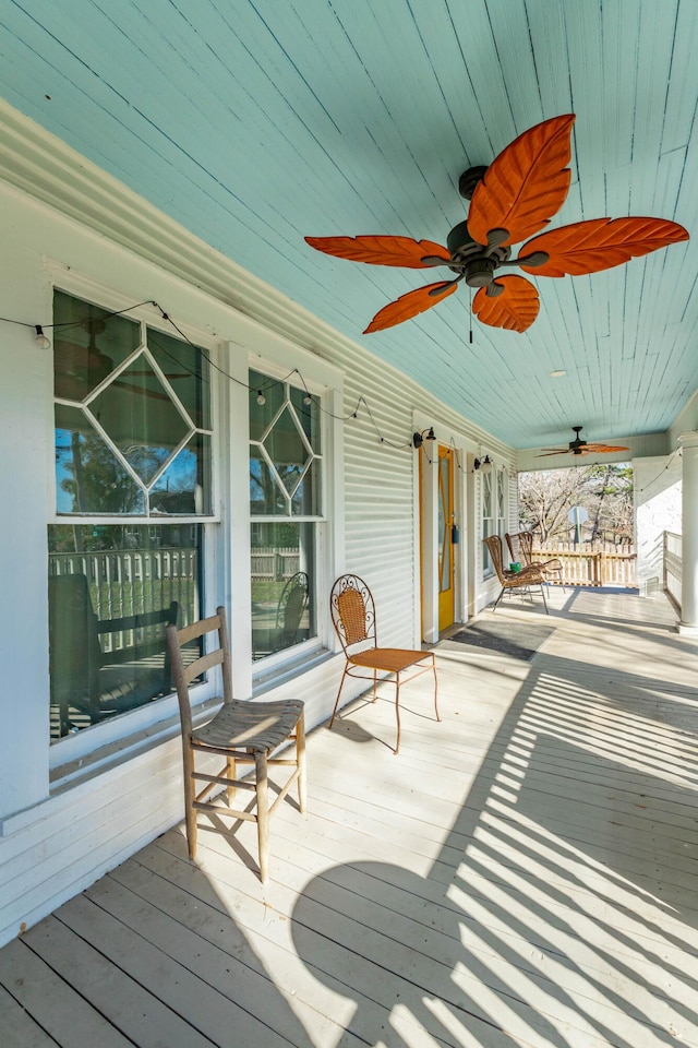 deck with a porch and a ceiling fan