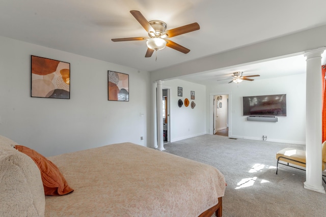 carpeted bedroom with baseboards, a ceiling fan, and ornate columns