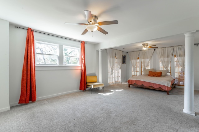 unfurnished bedroom with carpet floors, ornate columns, baseboards, and a ceiling fan