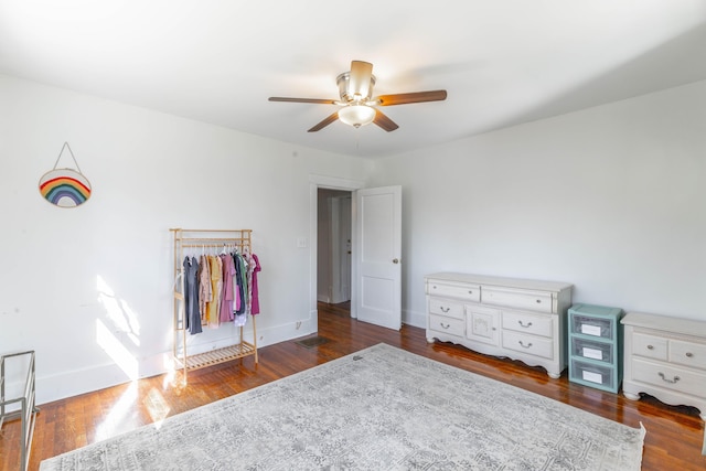 unfurnished bedroom with ceiling fan, dark wood finished floors, and baseboards