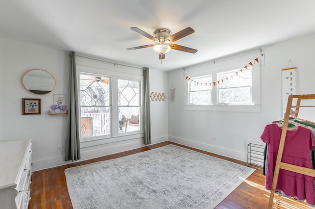 bedroom with dark wood-type flooring, baseboards, and a ceiling fan