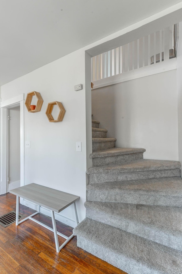 stairs featuring hardwood / wood-style flooring