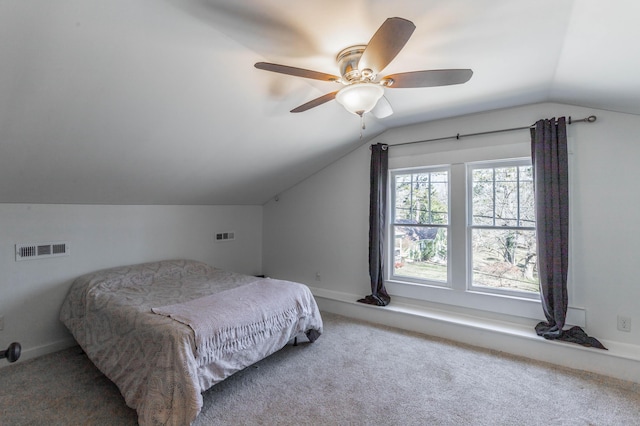 bedroom with carpet floors, ceiling fan, visible vents, and vaulted ceiling