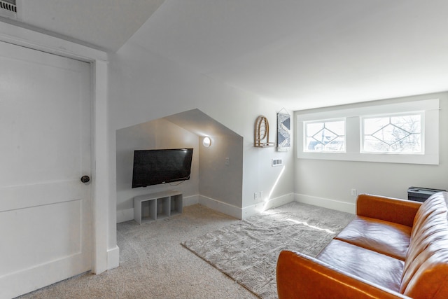 living room with light carpet, visible vents, and baseboards