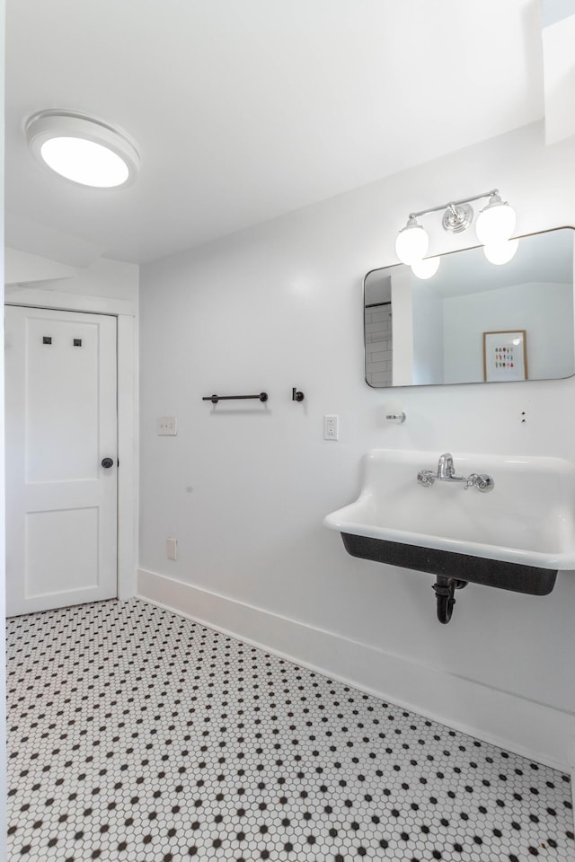 bathroom with baseboards and a sink