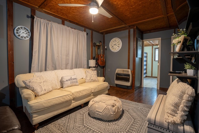 living room with dark hardwood / wood-style floors, ceiling fan, and heating unit