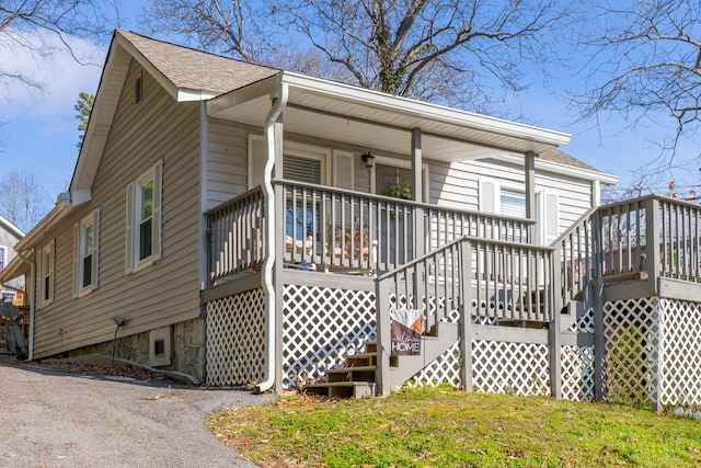 view of front of home with stairs, a shingled roof, and a porch