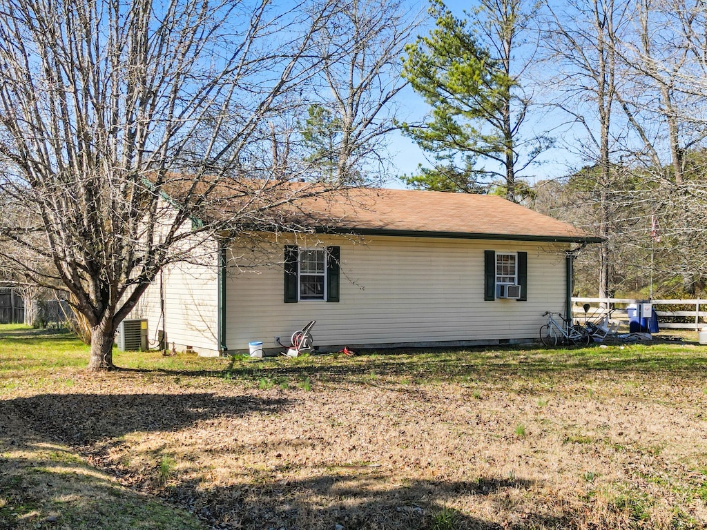 view of home's exterior featuring crawl space, fence, cooling unit, and a yard