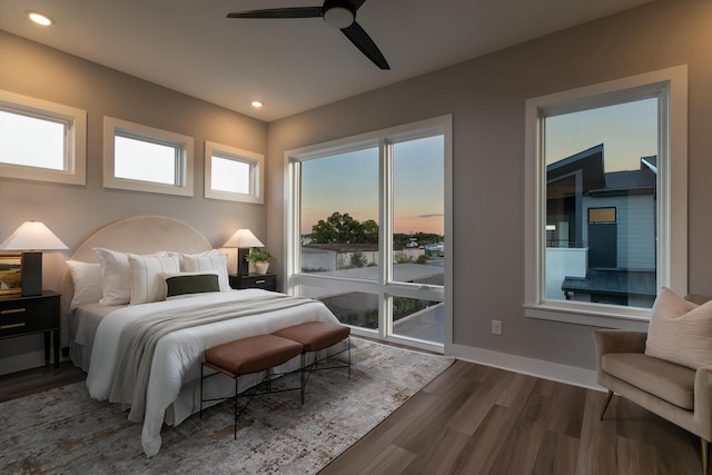 bedroom with dark hardwood / wood-style floors and ceiling fan