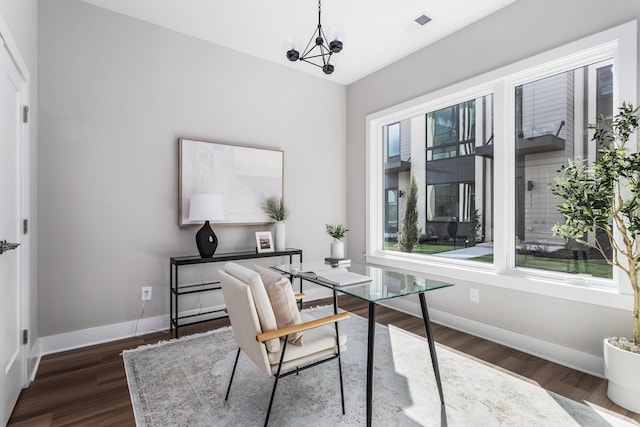 office with dark hardwood / wood-style floors and a chandelier