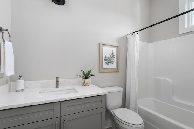 full bathroom with vanity, shower / bath combination with curtain, and toilet