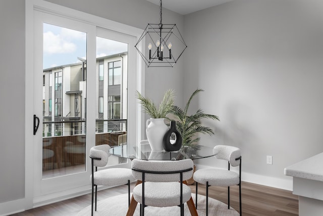 dining area featuring an inviting chandelier and wood-type flooring