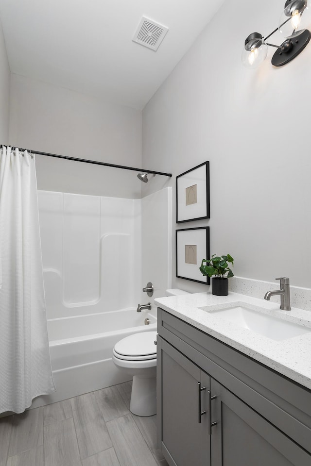 full bathroom with vanity, toilet, and shower / bath combo with shower curtain