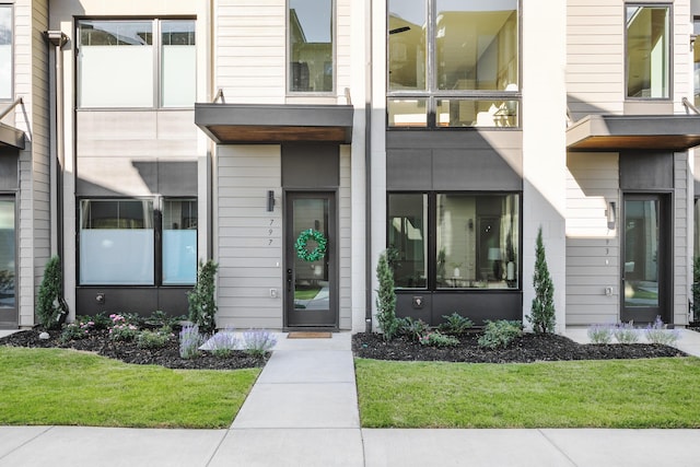 doorway to property with a lawn