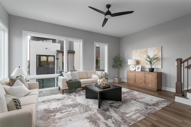 living room featuring a fireplace, dark hardwood / wood-style floors, and ceiling fan