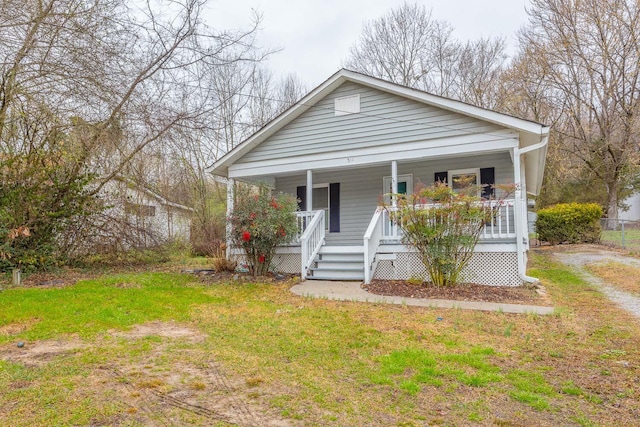 bungalow-style home featuring a front yard and covered porch