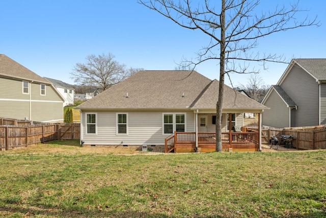 rear view of house featuring a deck and a lawn