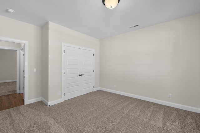 8918 Knolling Lp Unit 32, Ooltewah, TN 37363 - unfurnished bedroom featuring carpet, a closet, and baseboards