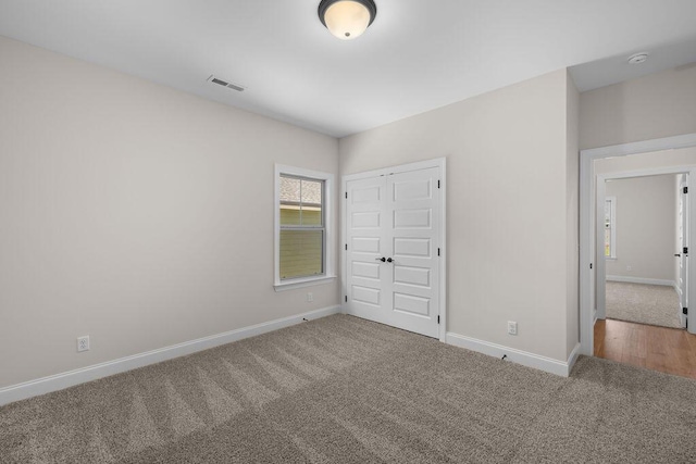 8918 Knolling Lp Unit 32, Ooltewah, TN 37363 - unfurnished bedroom with carpet, baseboards, and a closet