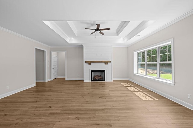 8918 Knolling Lp Unit 32, Ooltewah, TN 37363 - unfurnished living room with crown molding, a raised ceiling, a ceiling fan, light wood-style flooring, and a large fireplace