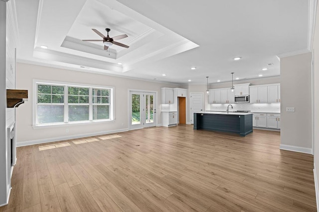 8918 Knolling Lp Unit 32, Ooltewah, TN 37363 - unfurnished living room with crown molding, ceiling fan, healthy amount of natural light, a sink, and light wood-style floors
