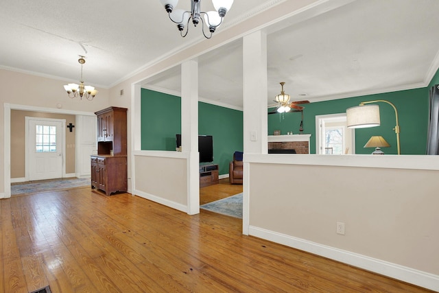 interior space featuring hardwood / wood-style flooring, ceiling fan with notable chandelier, and a wealth of natural light