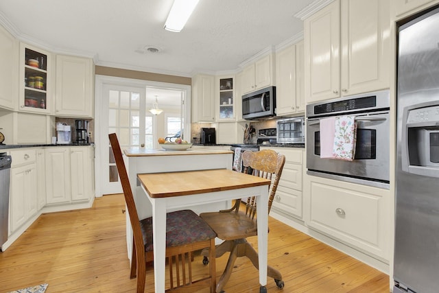 kitchen featuring white cabinetry, light hardwood / wood-style floors, and appliances with stainless steel finishes