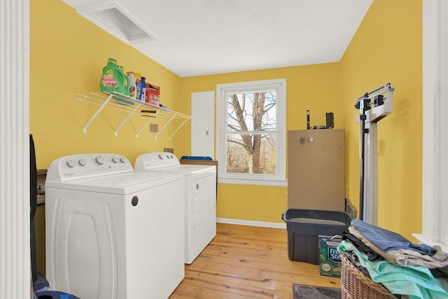 laundry area featuring light hardwood / wood-style floors and washer and dryer