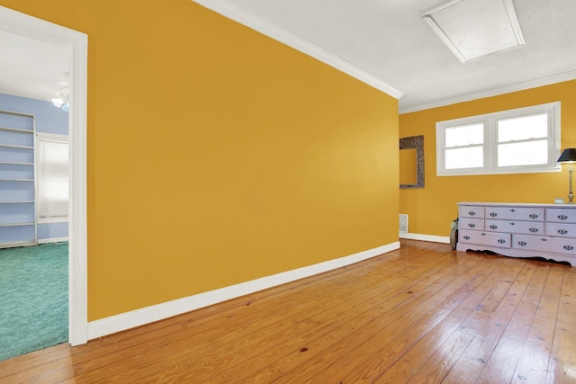 unfurnished room with ornamental molding and hardwood / wood-style floors