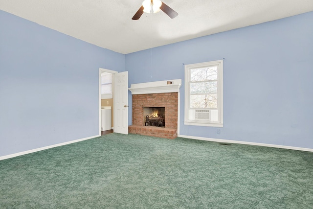 unfurnished living room featuring cooling unit, ceiling fan, a fireplace, and carpet floors