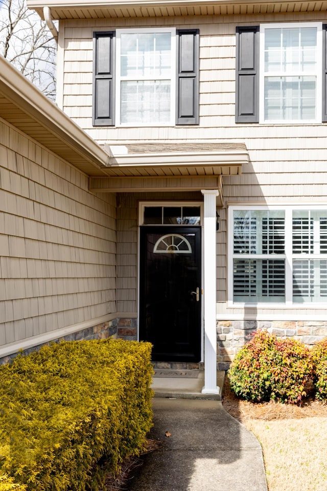 entrance to property featuring stone siding