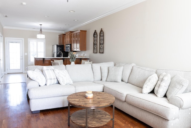 living area with ornamental molding, recessed lighting, visible vents, and wood finished floors