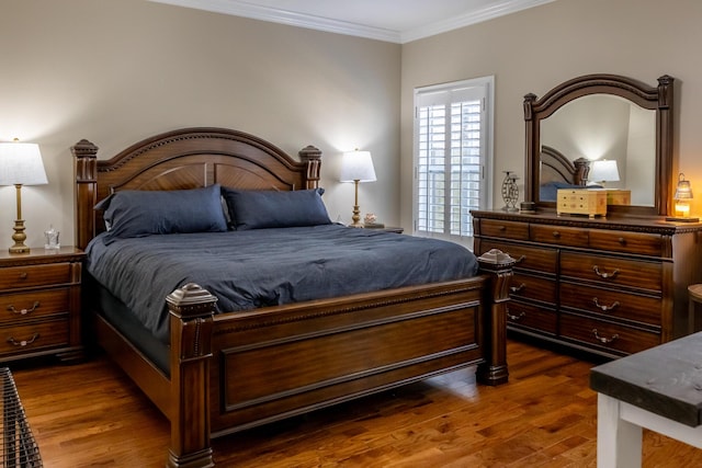 bedroom featuring dark wood-type flooring and crown molding