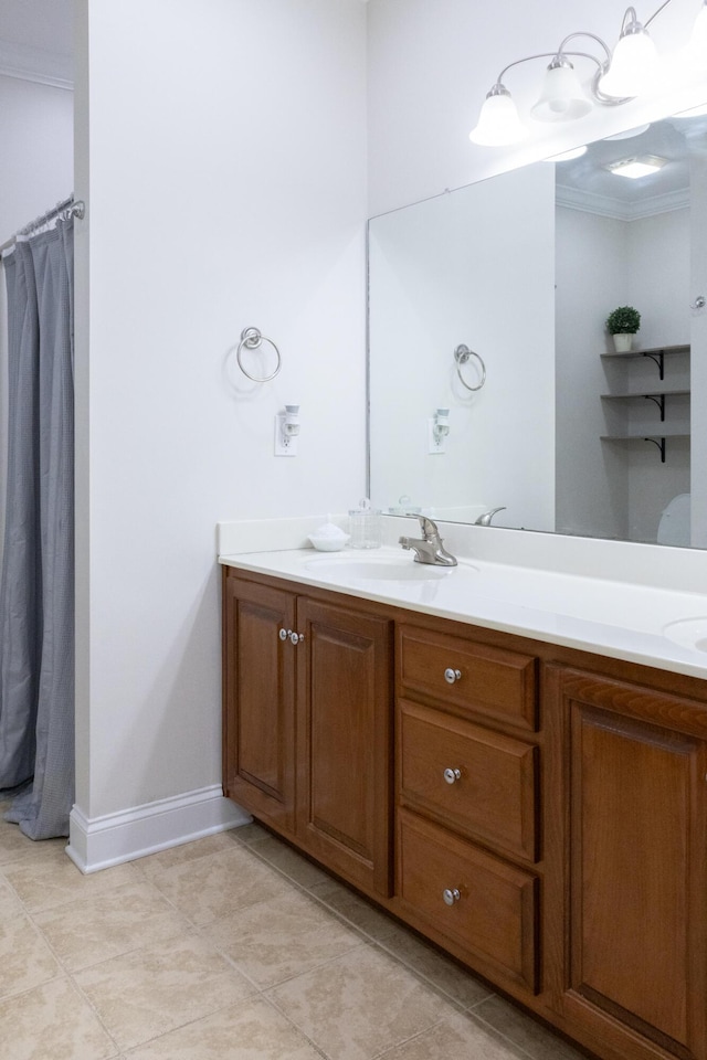 full bathroom with tile patterned floors, a sink, baseboards, and double vanity