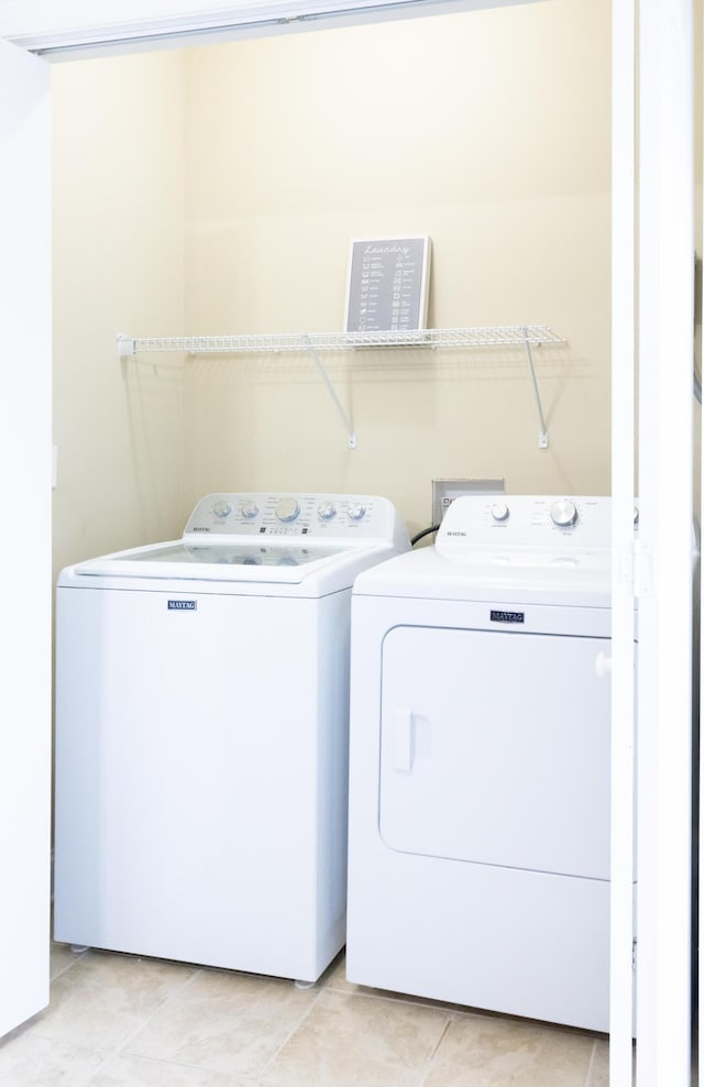 laundry room featuring laundry area, light tile patterned flooring, and independent washer and dryer