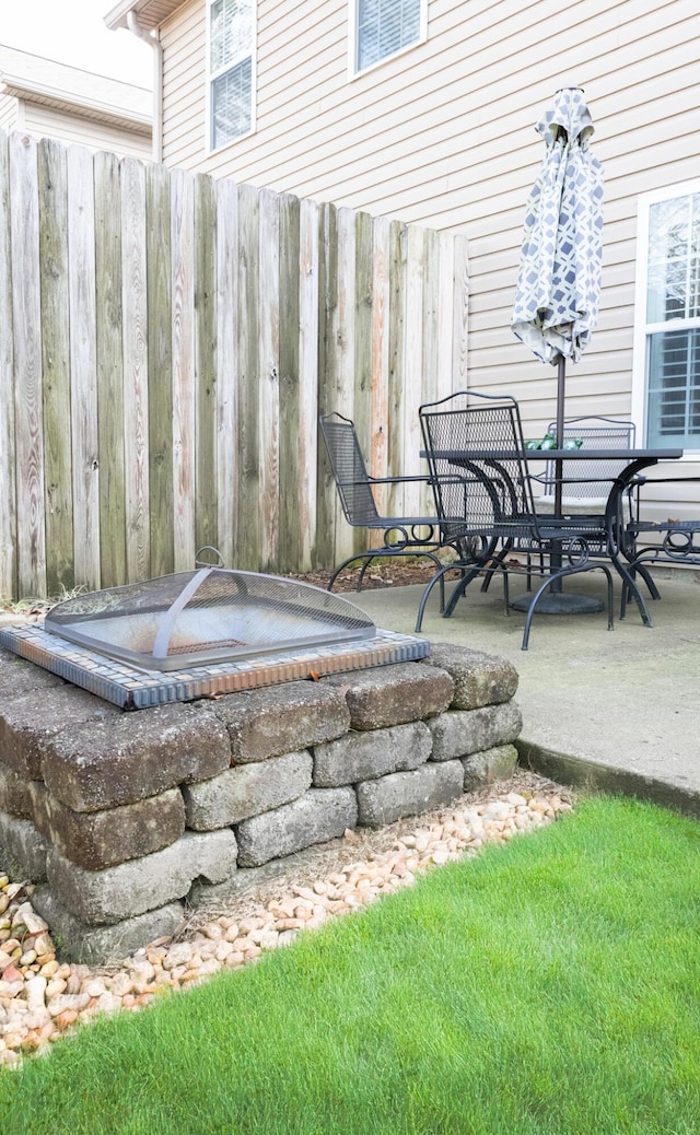 view of patio featuring fence and outdoor dining area