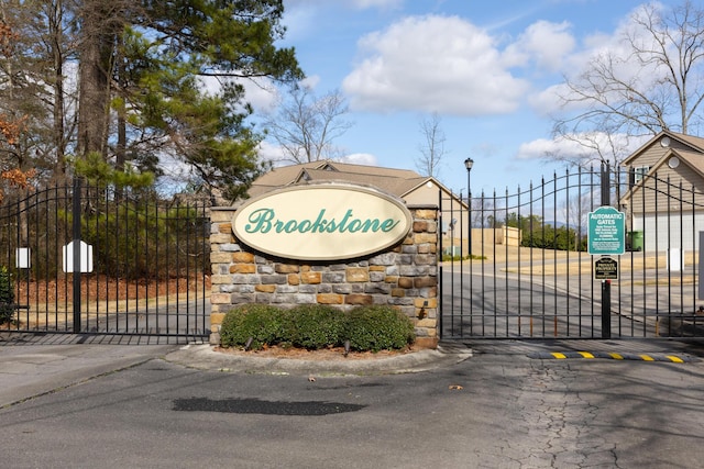 community sign featuring a gate