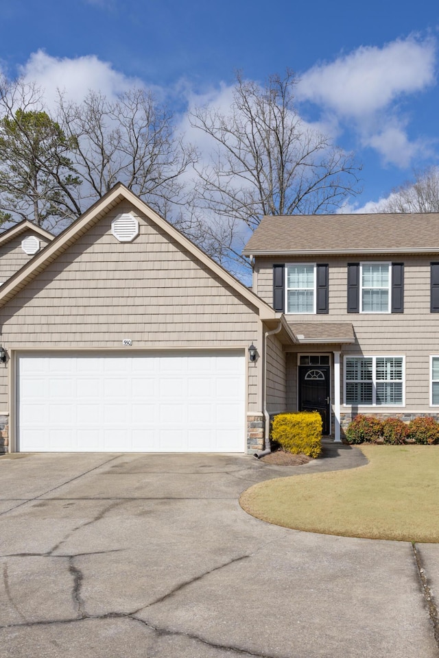 view of front of home with a garage, stone siding, aphalt driveway, and a front yard