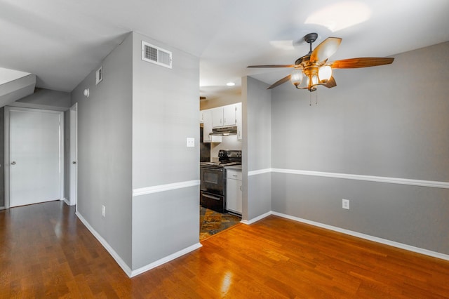 hall with baseboards, visible vents, and dark wood-style flooring