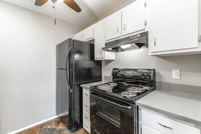 kitchen with light countertops, stone finish floor, white cabinets, under cabinet range hood, and black appliances