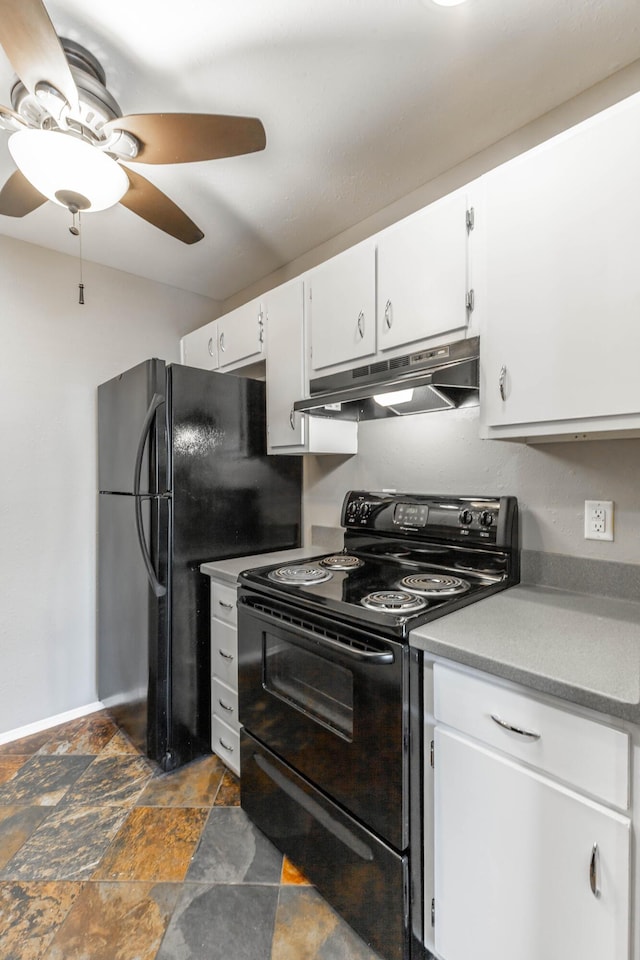 kitchen with light countertops, stone finish floor, white cabinetry, under cabinet range hood, and black appliances