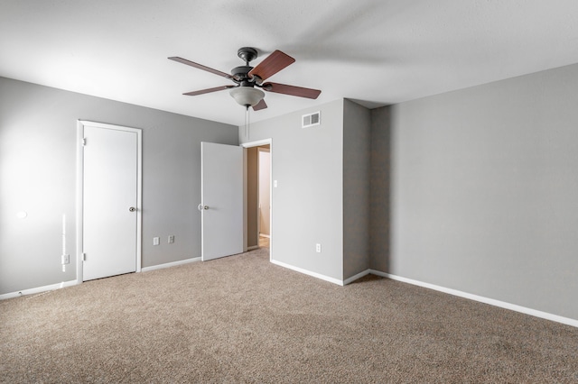 unfurnished bedroom with a ceiling fan, baseboards, visible vents, and carpet flooring