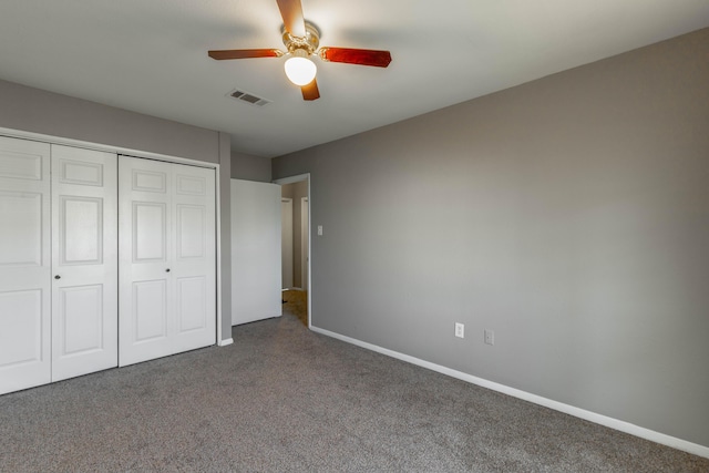 unfurnished bedroom featuring a closet, visible vents, a ceiling fan, carpet flooring, and baseboards