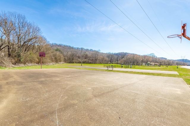 view of basketball court featuring community basketball court and a yard