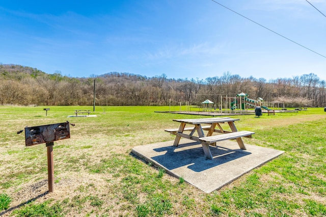 view of home's community with a lawn and playground community