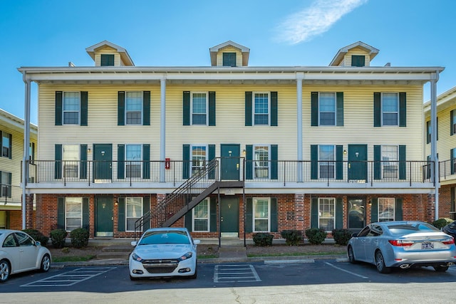 view of property with uncovered parking